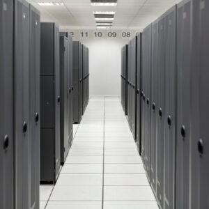 A data center aisle with tall gray server racks on both sides