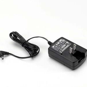 Black AC adapter with a coiled cord and plug on a white background