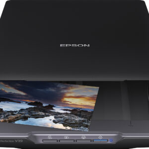 Flatbed scanner with lid closed scanning a photo of a rocky shoreline at sunset