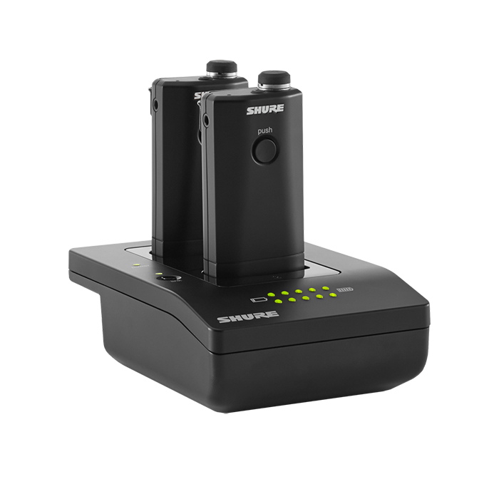 Estación DE Carga EN Red Shure MXWNCS2 vista 2 JFM Technology Shure wireless microphone belt pack transmitters resting in a charging dock with leds on the base